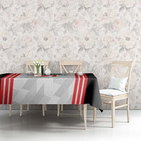 Football tablecloth on rectangular table with black, white, and red striped center panel