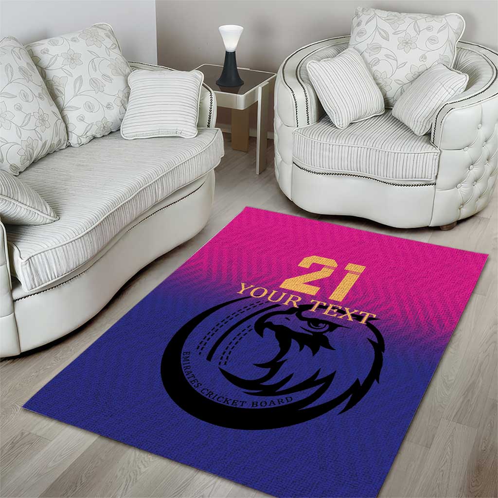 Custom cricket area rug on wood floor, blue and pink with falcon '21' design