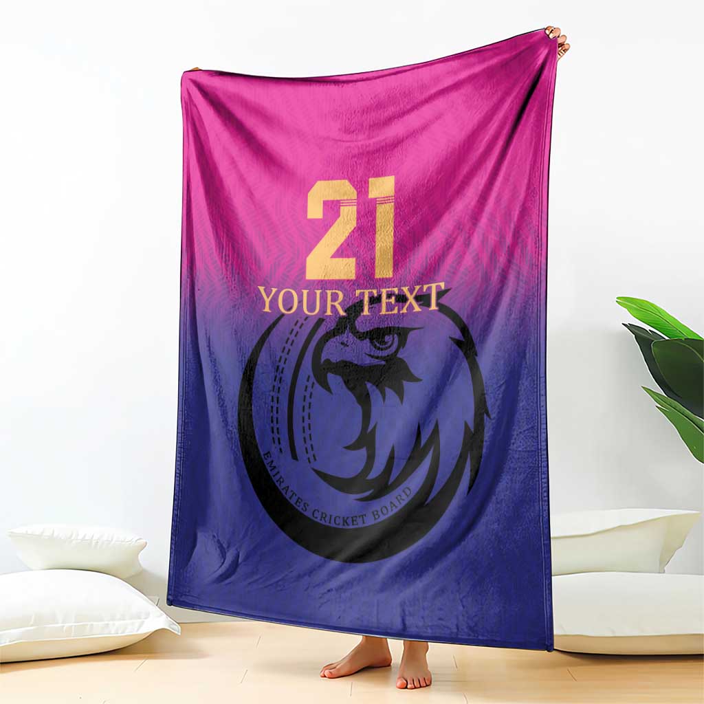 Cricket blanket, pink-and-blue gradient with large 21 and falcon logo, draped