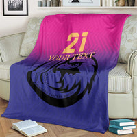 Cricket blanket on cream sofa, pink upper panel and blue lower panel with falcon 21