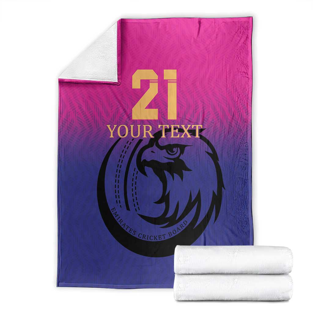 Cricket blanket folded and stacked with white towels, pink and blue falcon 21 print