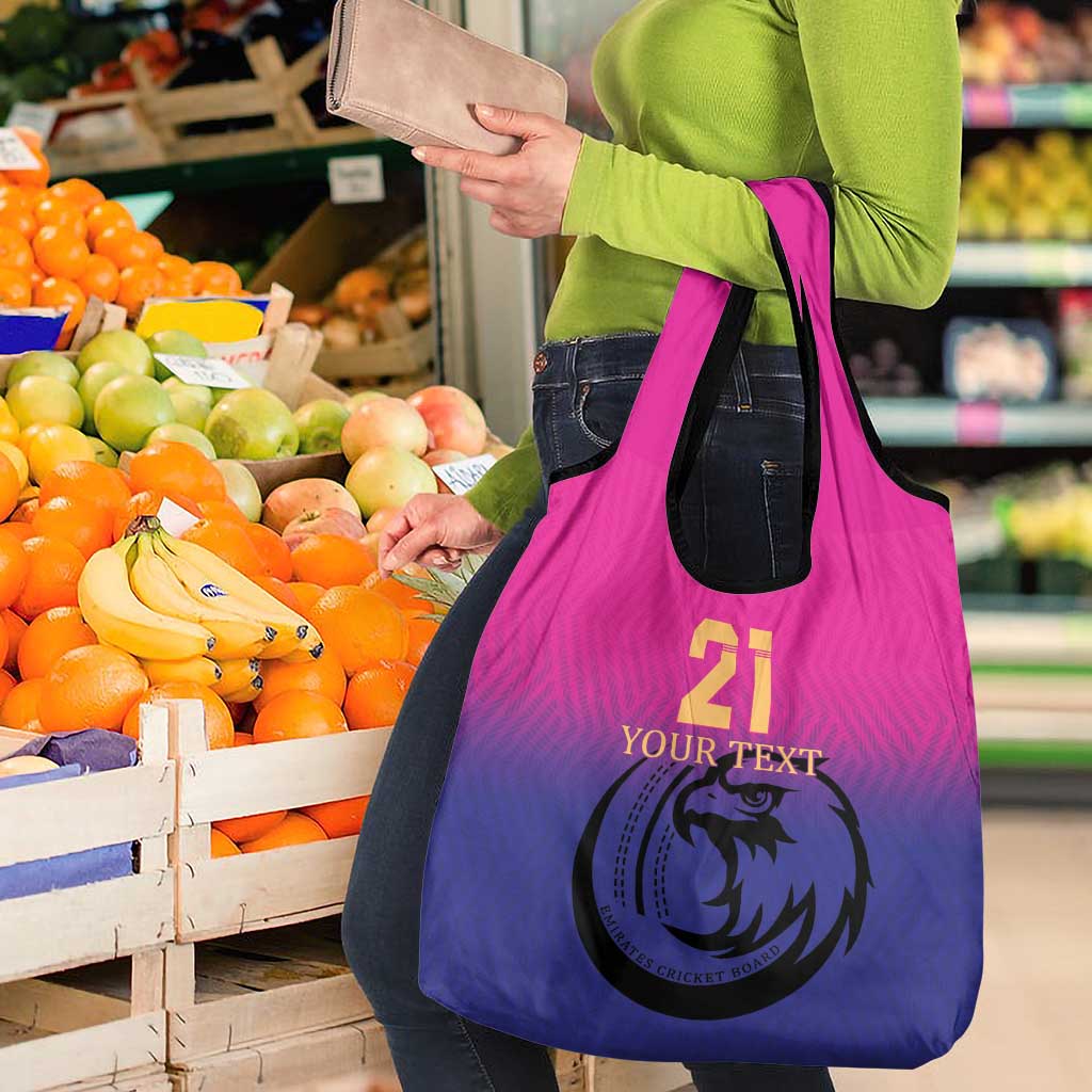 Pink-to-purple gradient tote bag with falcon emblem and produce graphic in front panel