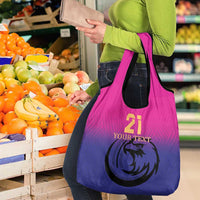Pink-to-purple gradient tote bag with falcon emblem and produce graphic in front panel