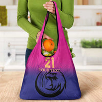 Pink-to-purple gradient tote bag with falcon emblem and produce packed in front pocket