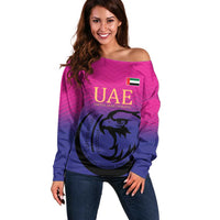 Women’s off-shoulder pink sweater with UAE crest and falcon graphic, long sleeves