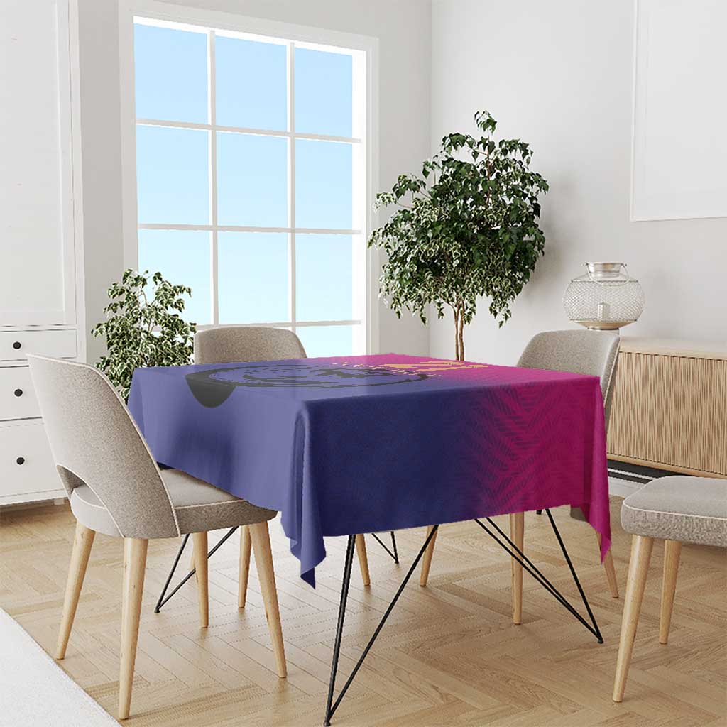 Pink and purple cricket tablecloth draped over rectangular dining table with hanging corners