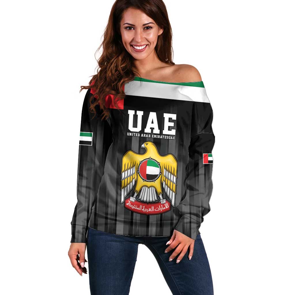 Black off-shoulder sweater with UAE flag stripe and crest graphic on front
