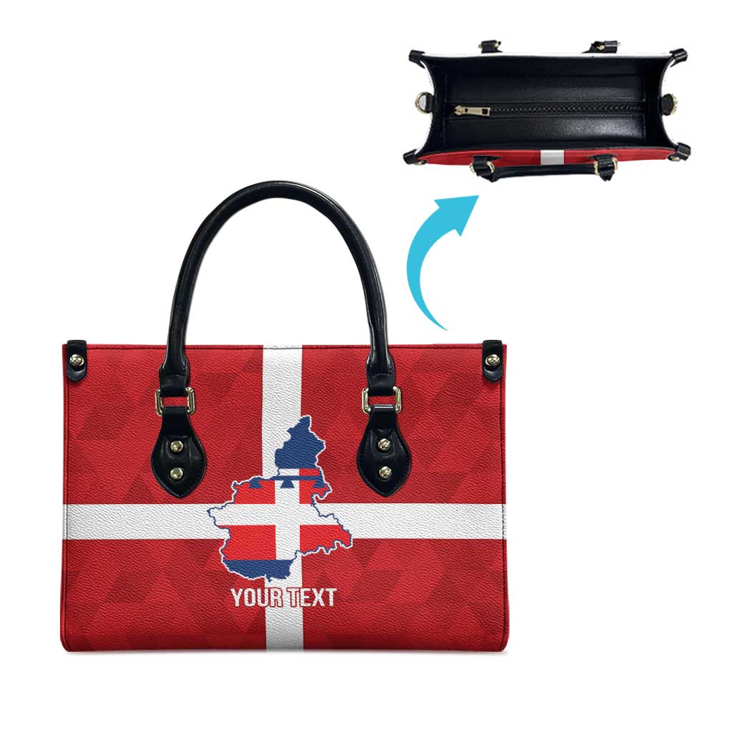 Red-and-white flag print tote bag with blue crest, black handles, and zipper compartment detail