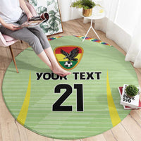 Green circular rug on floor with eagle soccer emblem and 'YOUR TEXT 21' center print