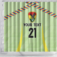 Green shower curtain with crest emblem, rainbow diagonal ribbons, and large '21' text