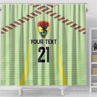 Green shower curtain with rainbow diagonal ribbons, crest emblem, and '21' centered
