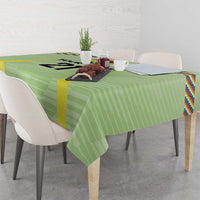 Green soccer tablecloth draped over table with multicolor Wiphala-style edge stripes