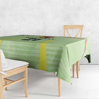 Green tablecloth with Wiphala-style multicolor panel and yellow vertical stripe along edge