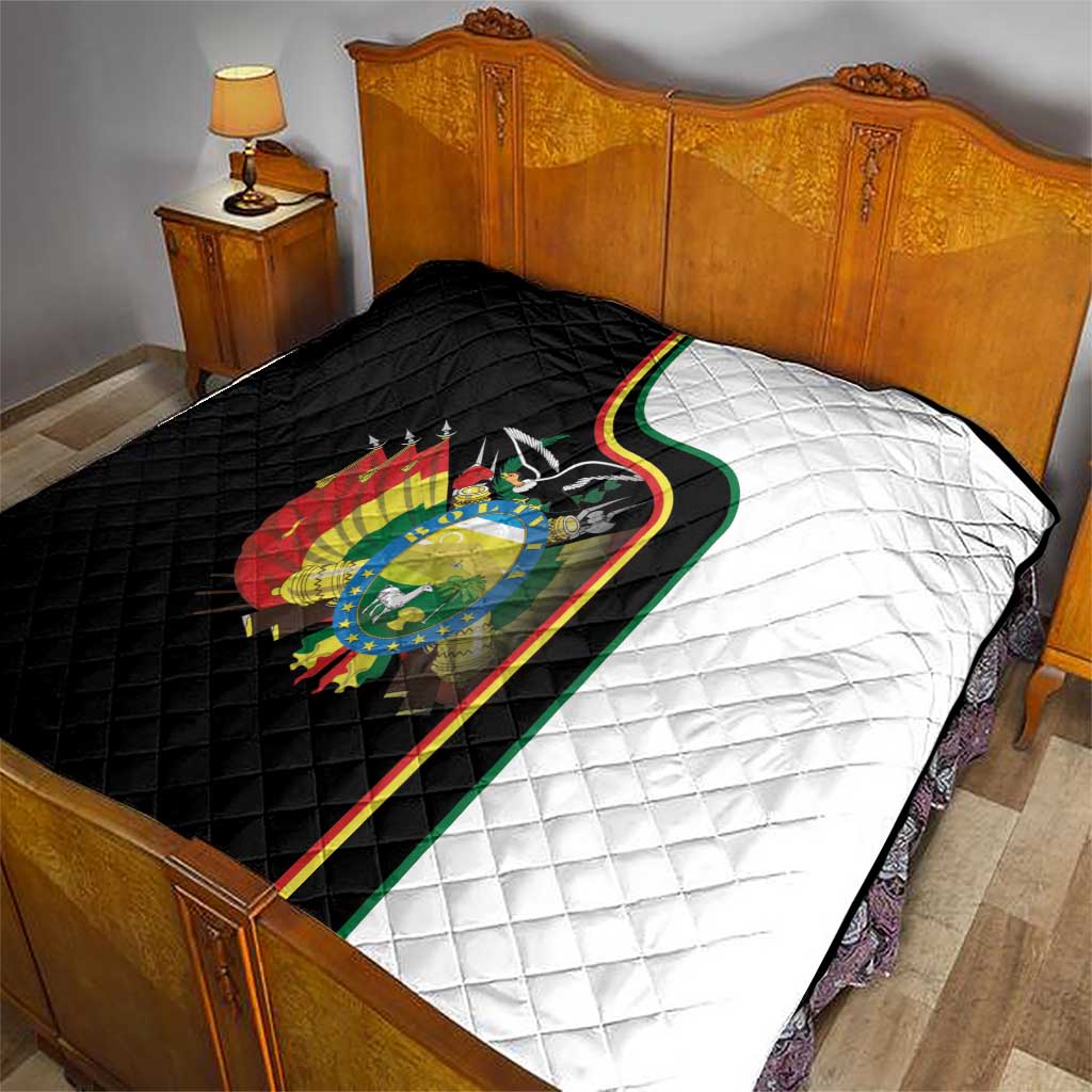 Quilt blanket on bed: black side, white side, green-yellow-red Bolivia coat of arms trim.
