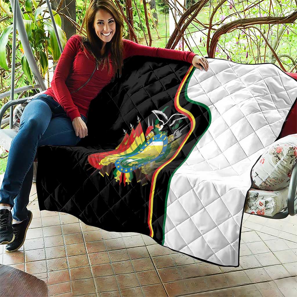 Quilt blanket draped over couch with black left, white right, and Bolivia coat of arms.