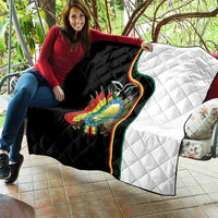 Quilt blanket draped over couch with black left, white right, and Bolivia coat of arms.