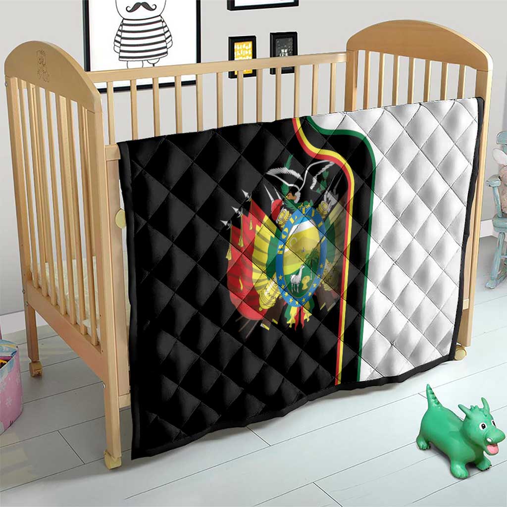 Quilt on a baby bed with black-and-white sections and Bolivia coat of arms emblem.
