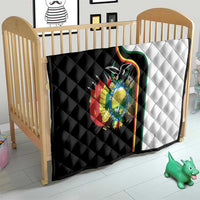 Quilt on a baby bed with black-and-white sections and Bolivia coat of arms emblem.