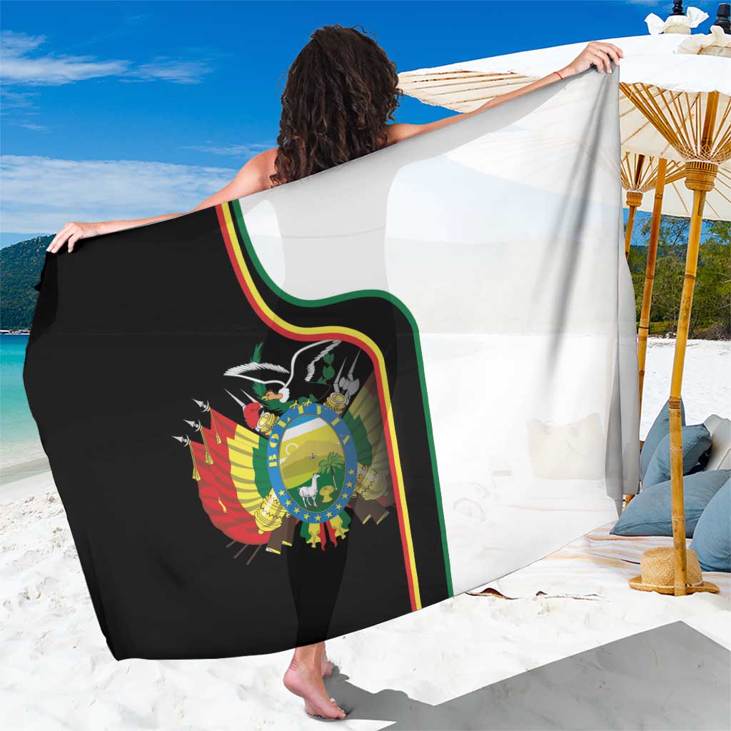 White and black coat of arms sarong with green red yellow edge trim and crest graphic