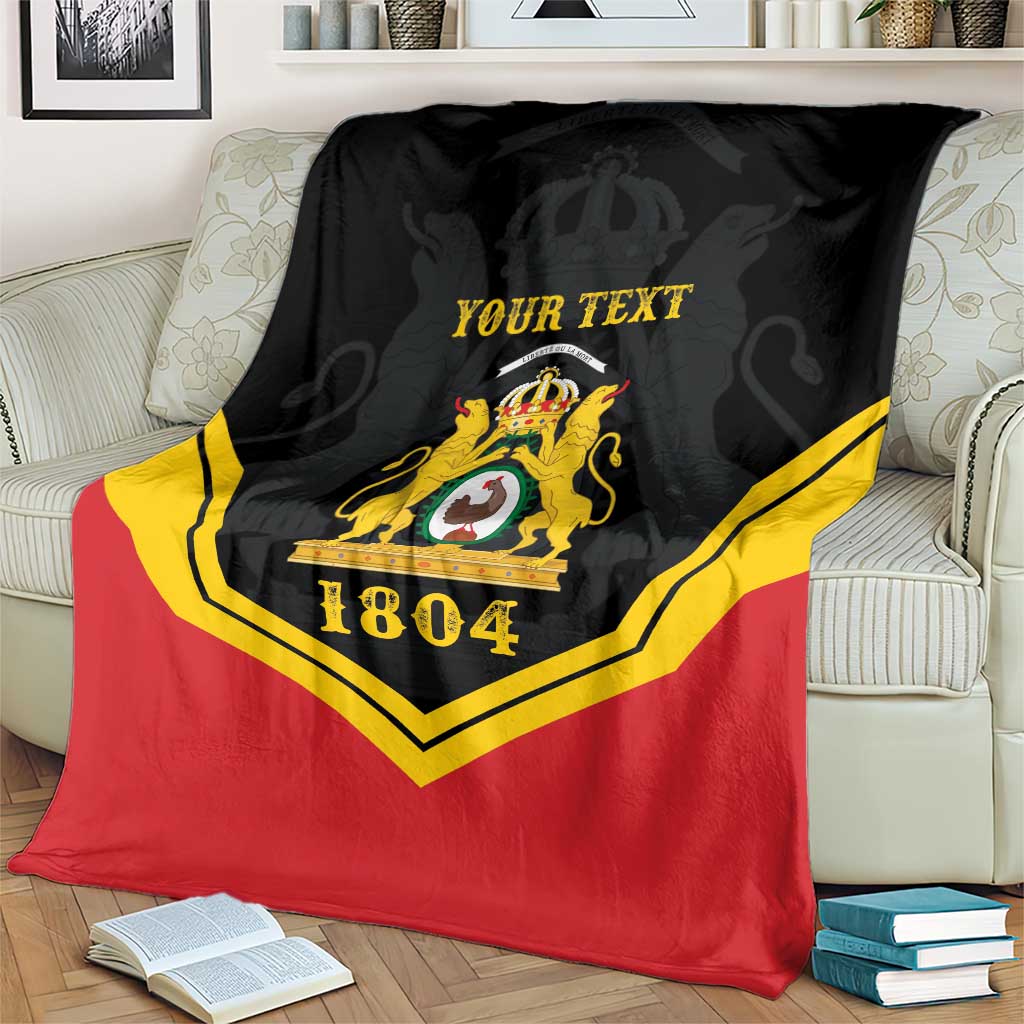 Black/red/yellow personalized throw blanket with crest and “YOUR TEXT”, 1804 on armchair