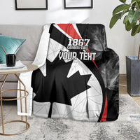 Personalized Canada Day blanket on the floor: black maple leaf, red stripe, and “YOUR TEXT”