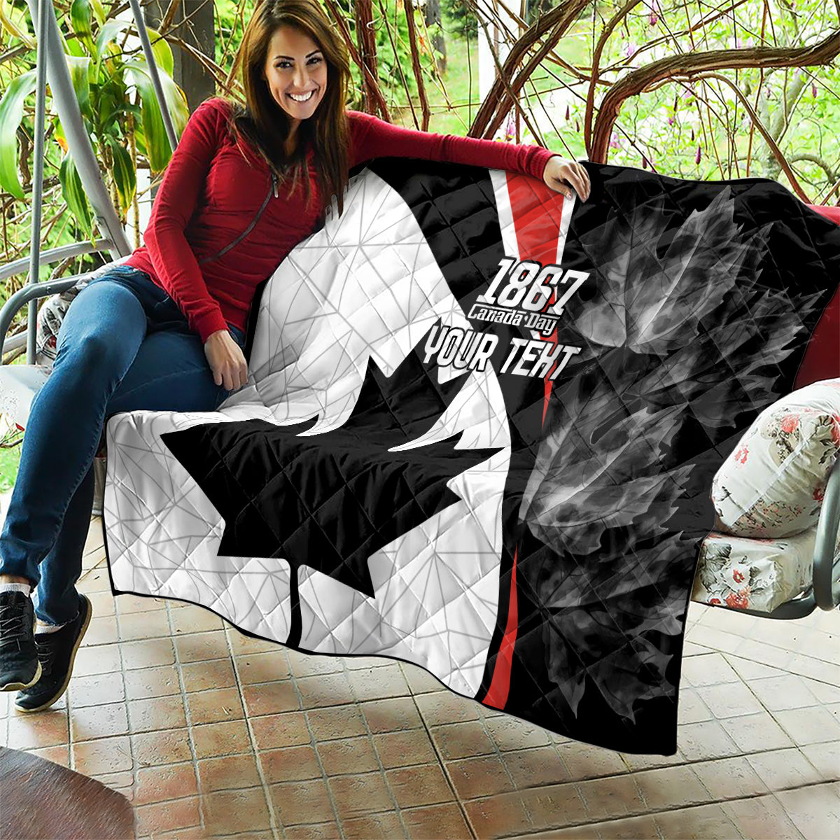 Black and white quilt with red stripe, quilted maple leaf and “YOUR TEXT”