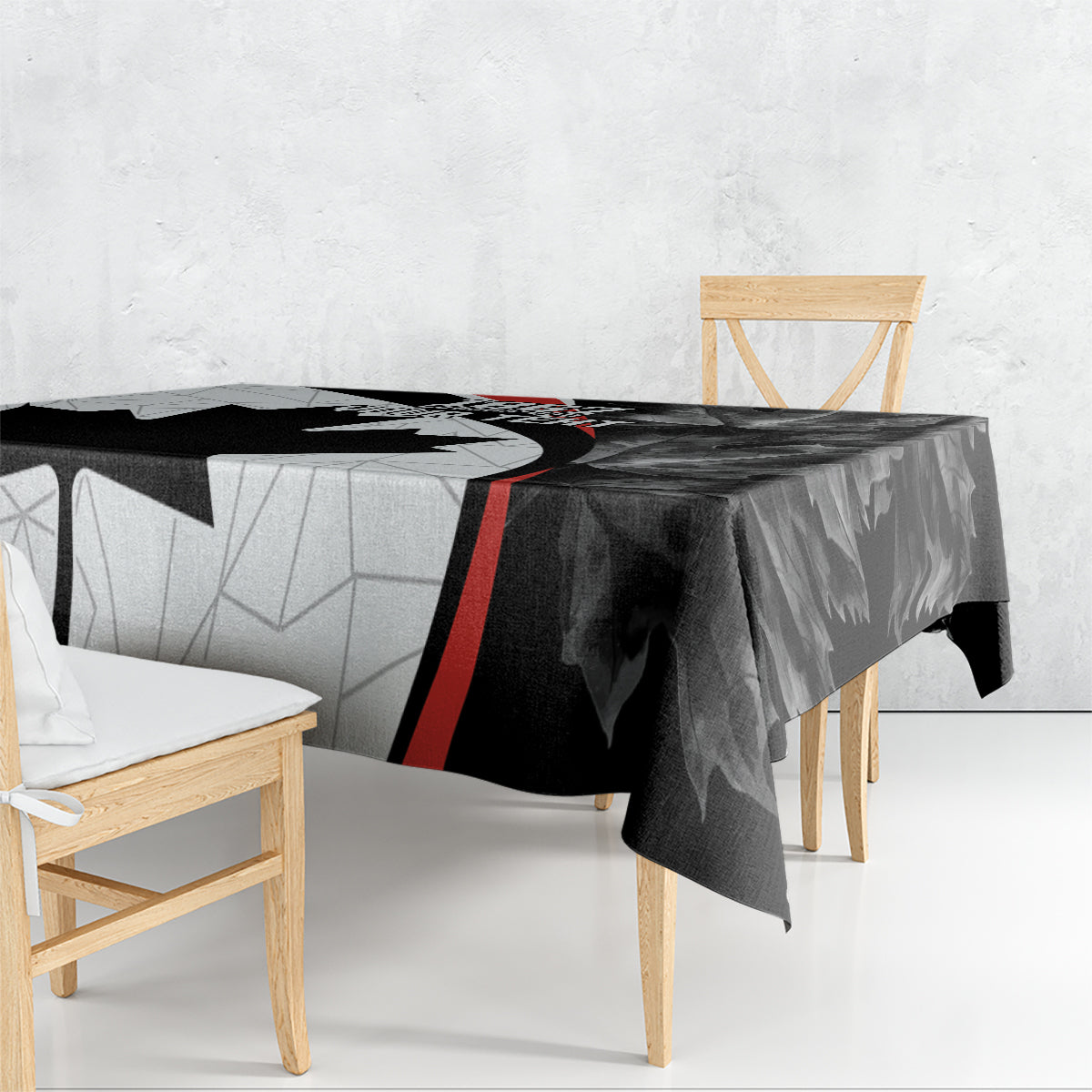 Black graphic Canada Day tablecloth draped over dining table with red stripe