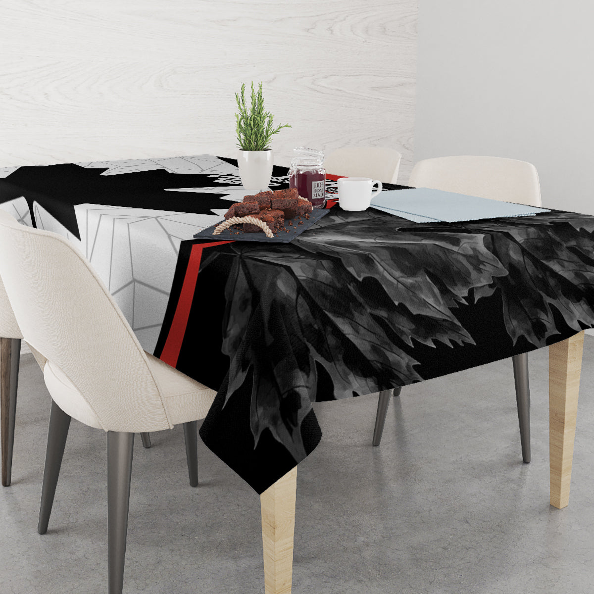 Black Canada Day tablecloth with maple leaf design and red stripe on dining table