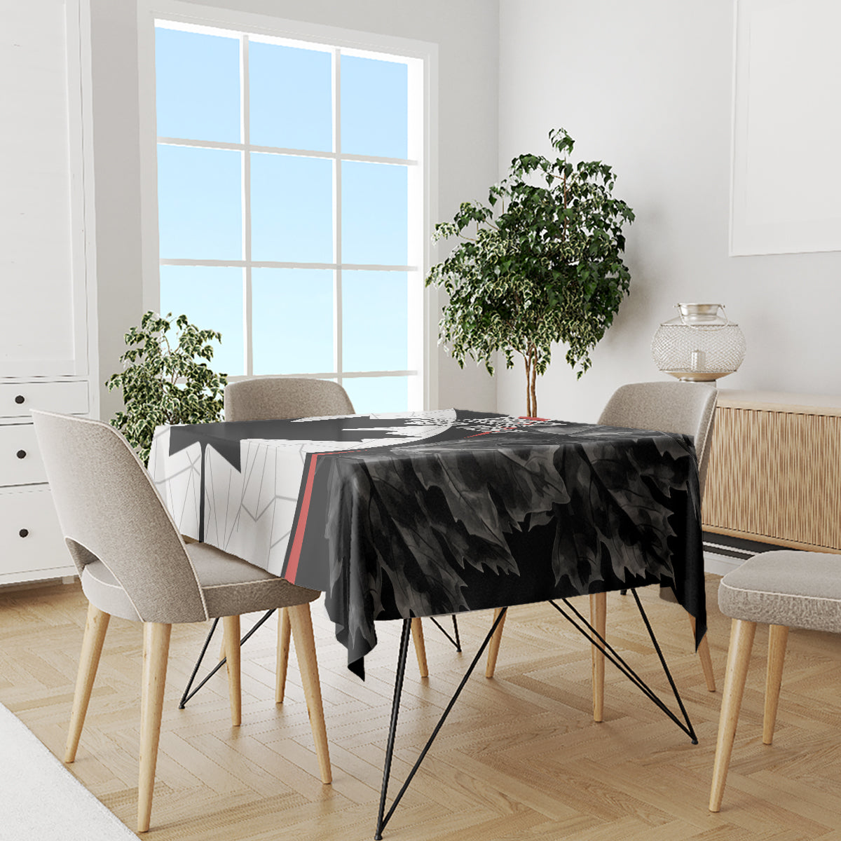 Black Canada Day tablecloth with maple leaf graphics and red stripe across dining table