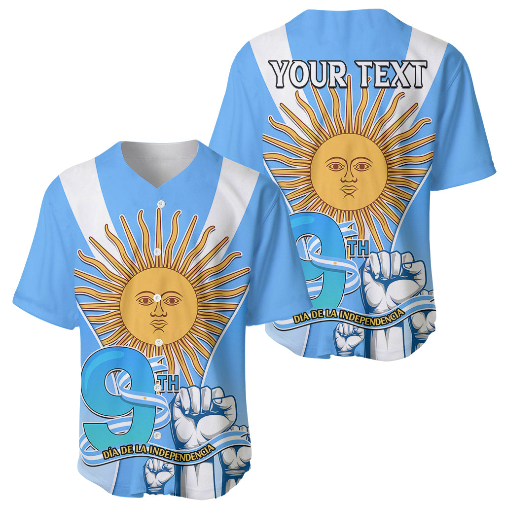 Two blue baseball jerseys with white V-strap and sun graphic; one shows 'YOUR TEXT'