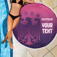 Round pink beach blanket with white fringe, Germany crest, stars, and “YOUR TEXT” graphic