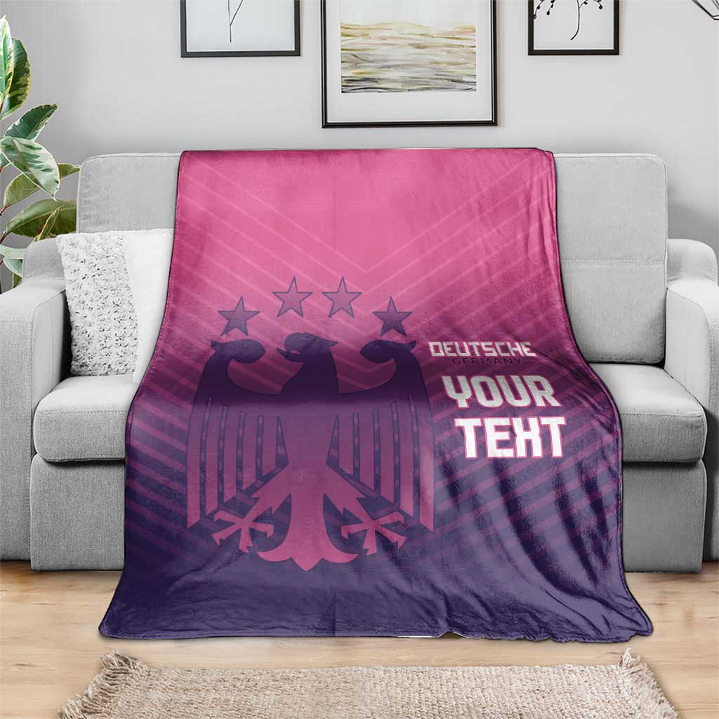Football-themed blanket on a gray sofa, pink-to-purple gradient with 'YOUR TEXT' design