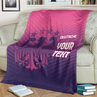 Football-themed blanket on a cream sofa, pink-to-purple gradient with 'YOUR TEXT' print