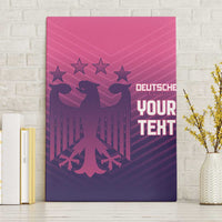 Pink canvas wall art with German eagle graphic and “YOUR TEXT” on light wall