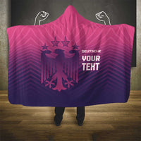 Pink and dark purple hooded blanket with Germany eagle crest and 'YOUR TEXT' lettering.