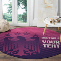 Round area rug with purple-pink football pattern, stars, and “DEUTSCHE YOUR TEHT”