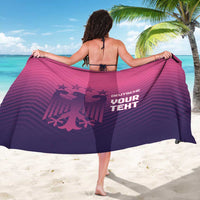 Pink and purple sarong draped wide, featuring football graphic and stacked lettering