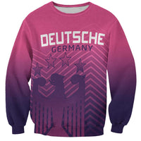 Pink crewneck sweatshirt with front graphic text and stars, dark cuffs and hem