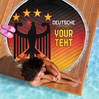 Round Germany flag beach blanket with red eagle emblem on black center, white fringe edge