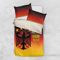 Flat-lay bedding set: gradient red-orange-yellow duvet and two pillows with black eagle graphic