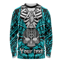 Aqua long-sleeve shirt with black and white skull graphic and tribal sleeve pattern
