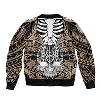 Bomber jacket with ribbed hem and cuffs, gold-toned tribal pattern, skull illustration, zip-up