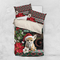 Black holiday comforter with fennec Santa, poinsettias, moon, and red-green geometric accents