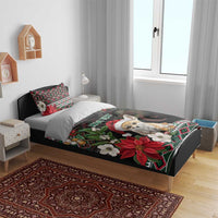 Black holiday bedding on bed: fennec Santa, poinsettias, moon, and colorful geometric trim