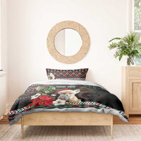 Black holiday duvet with fennec Santa, poinsettias, moon, and red-green patterned border