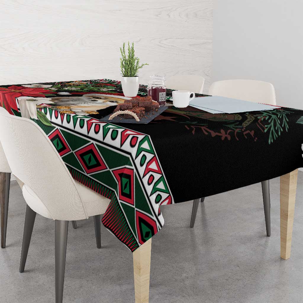 Christmas tablecloth on a dining table, black with green diamond pattern and red accents