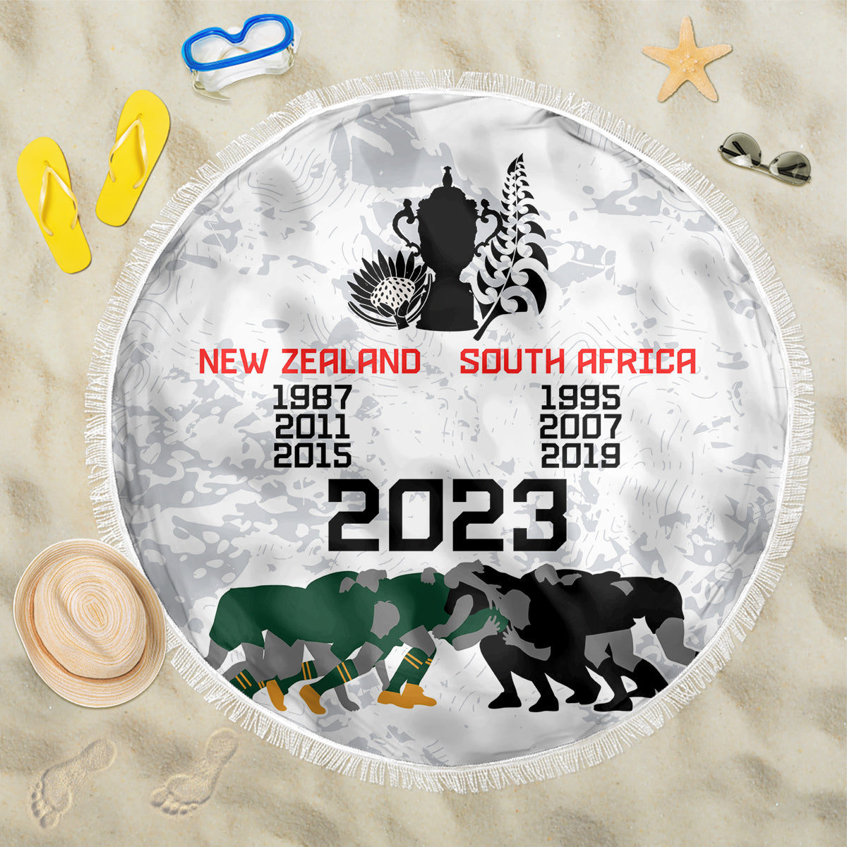 White round beach blanket with fringe, 2023 text and New Zealand/South Africa silhouettes