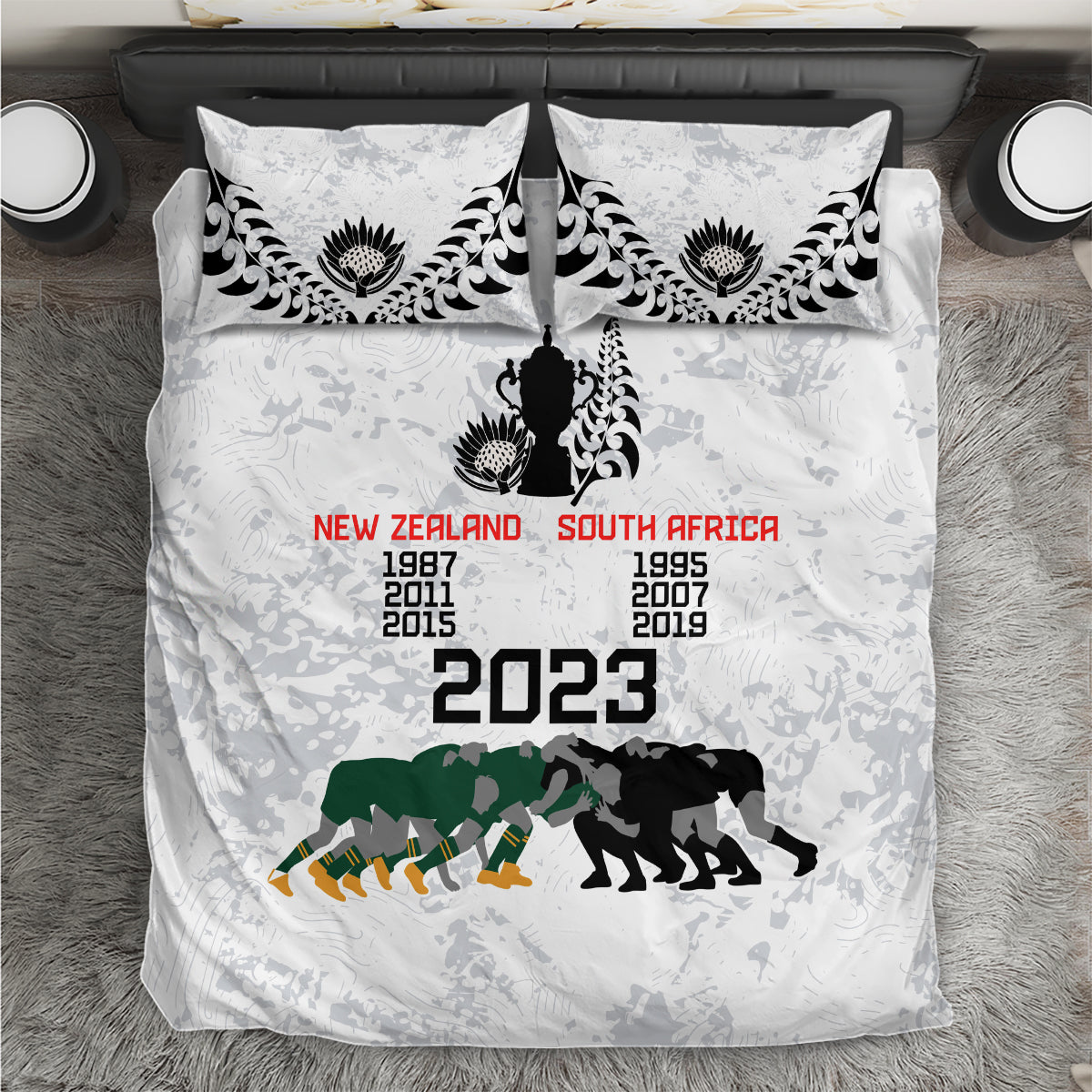 White duvet cover and pillows with black damask trim, rugby silhouettes and 2023 text