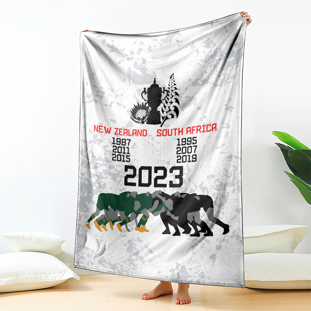 White commemorative rugby blanket with NZ vs South Africa 2023 text and team animal silhouettes
