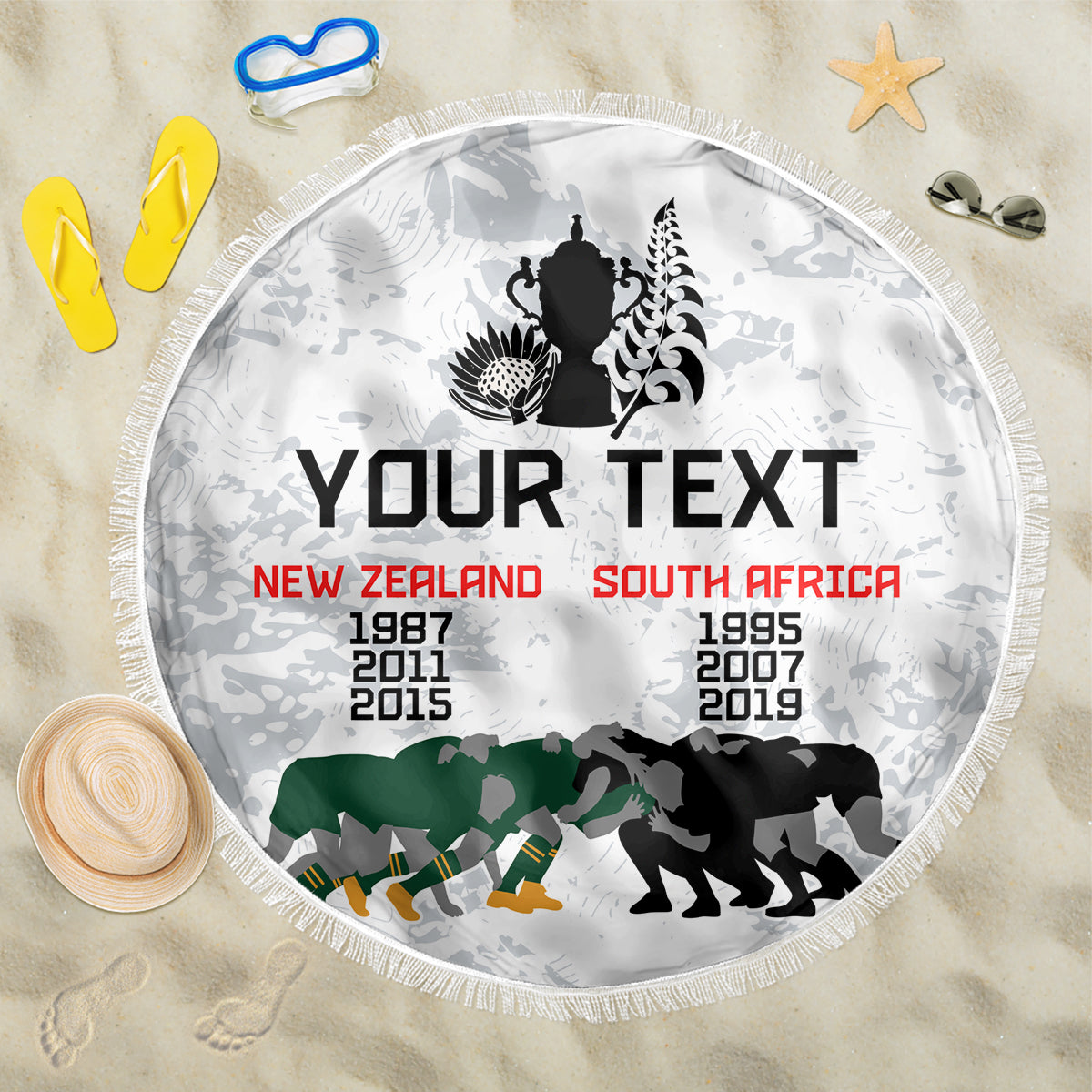 Round white beach blanket with fringe edge and bold sports-style graphic, editable text area.